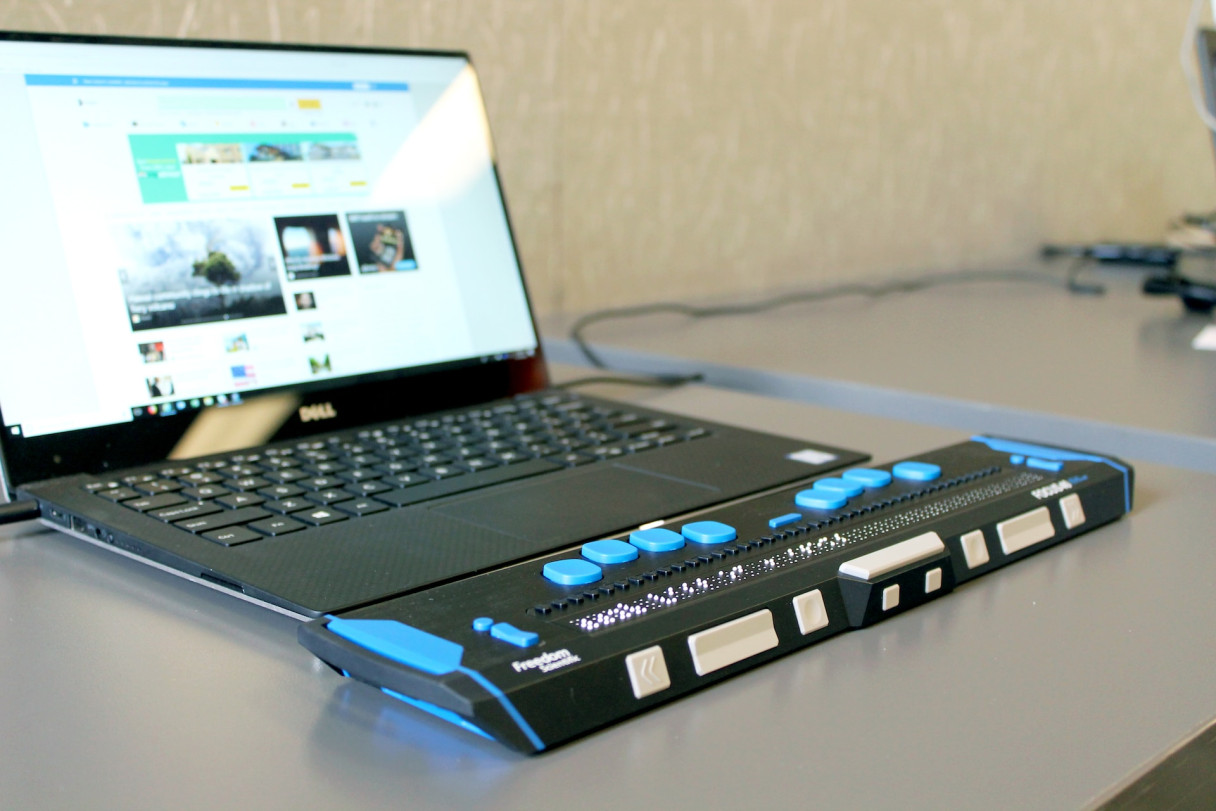 A laptop computer with a refreshable Braille display.